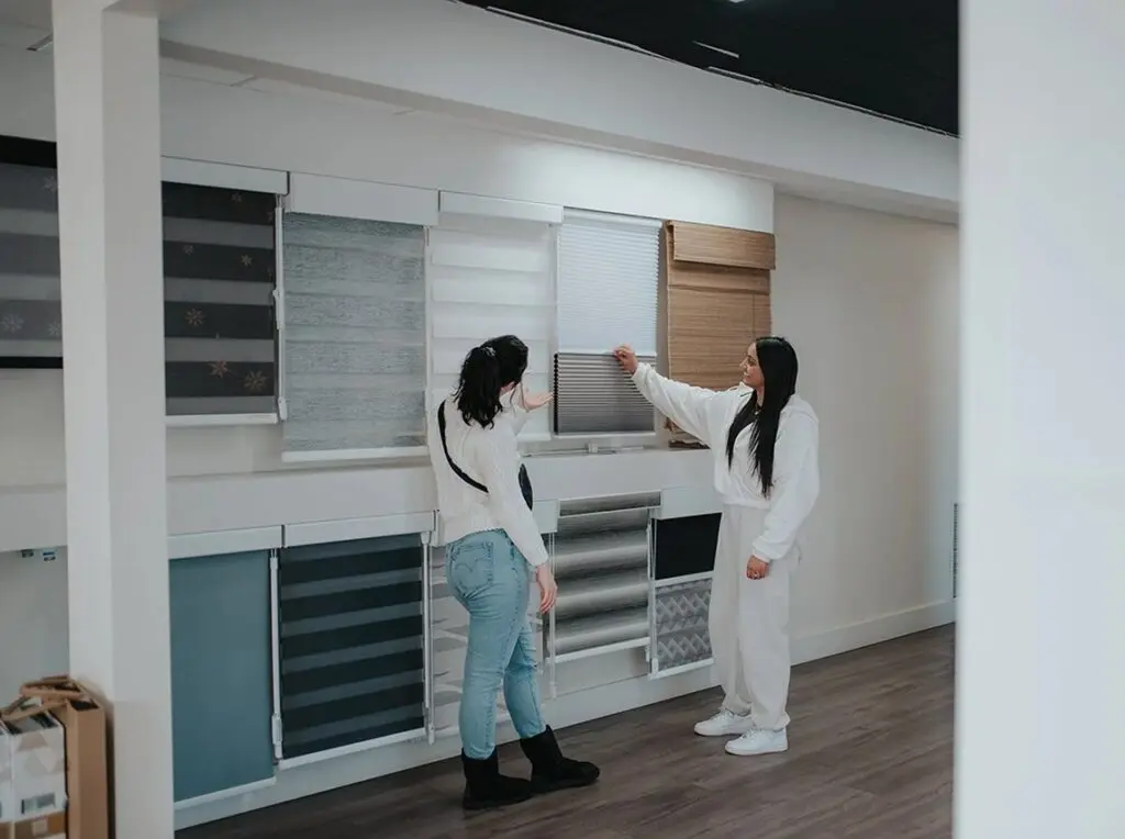 Customers shopping fabric samples in the Novo Blinds Edmonton showroom