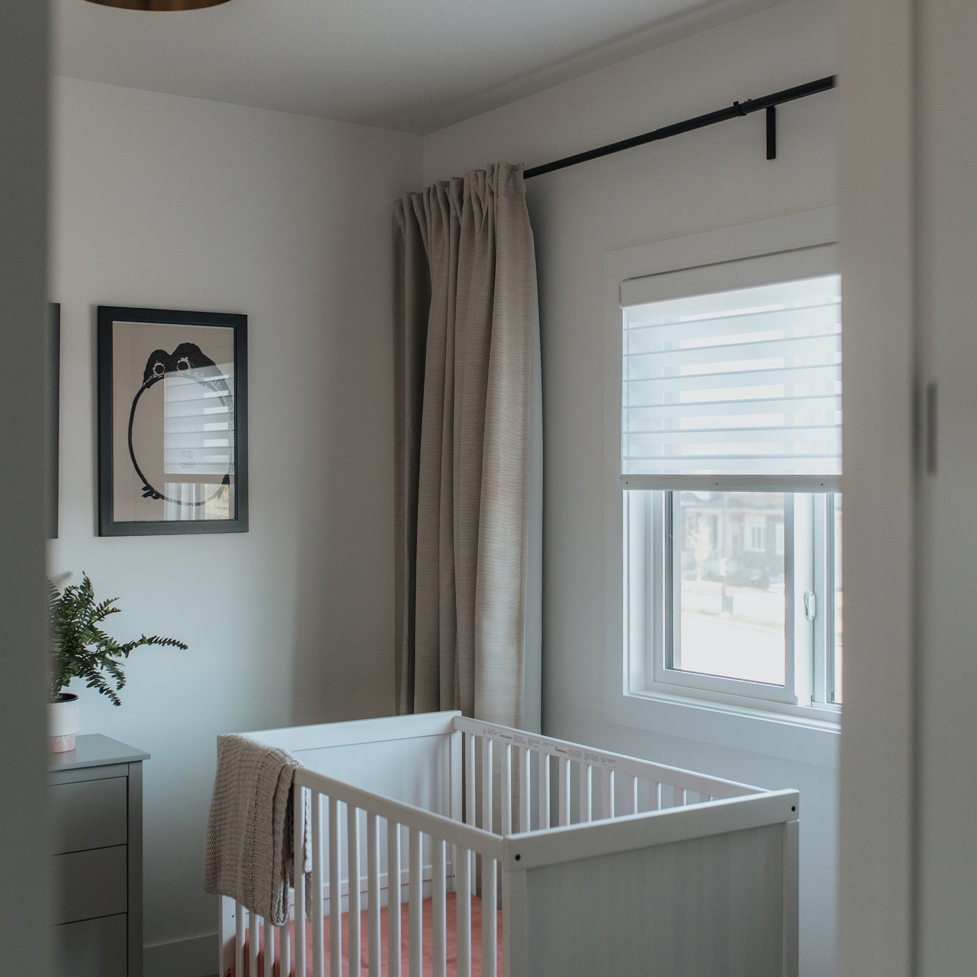 Living room with custom roller shades by Novo Blinds in a Sherwood Park home