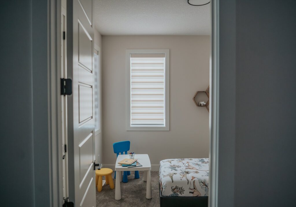 Sunlit Edmonton living room with custom roller shades by Novo Blinds