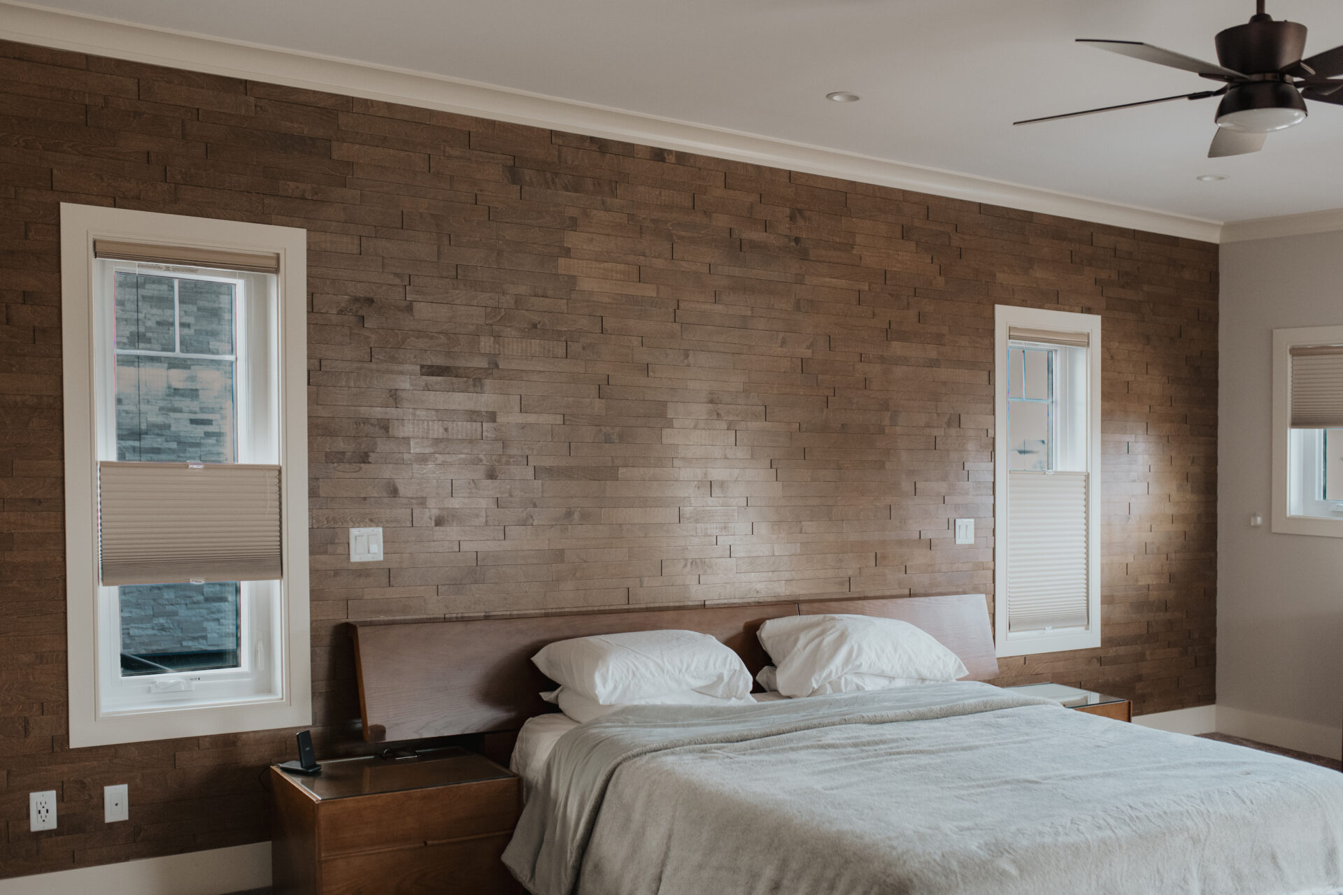 Custom residential bedroom blinds paired with a textured feature wall in Edmonton