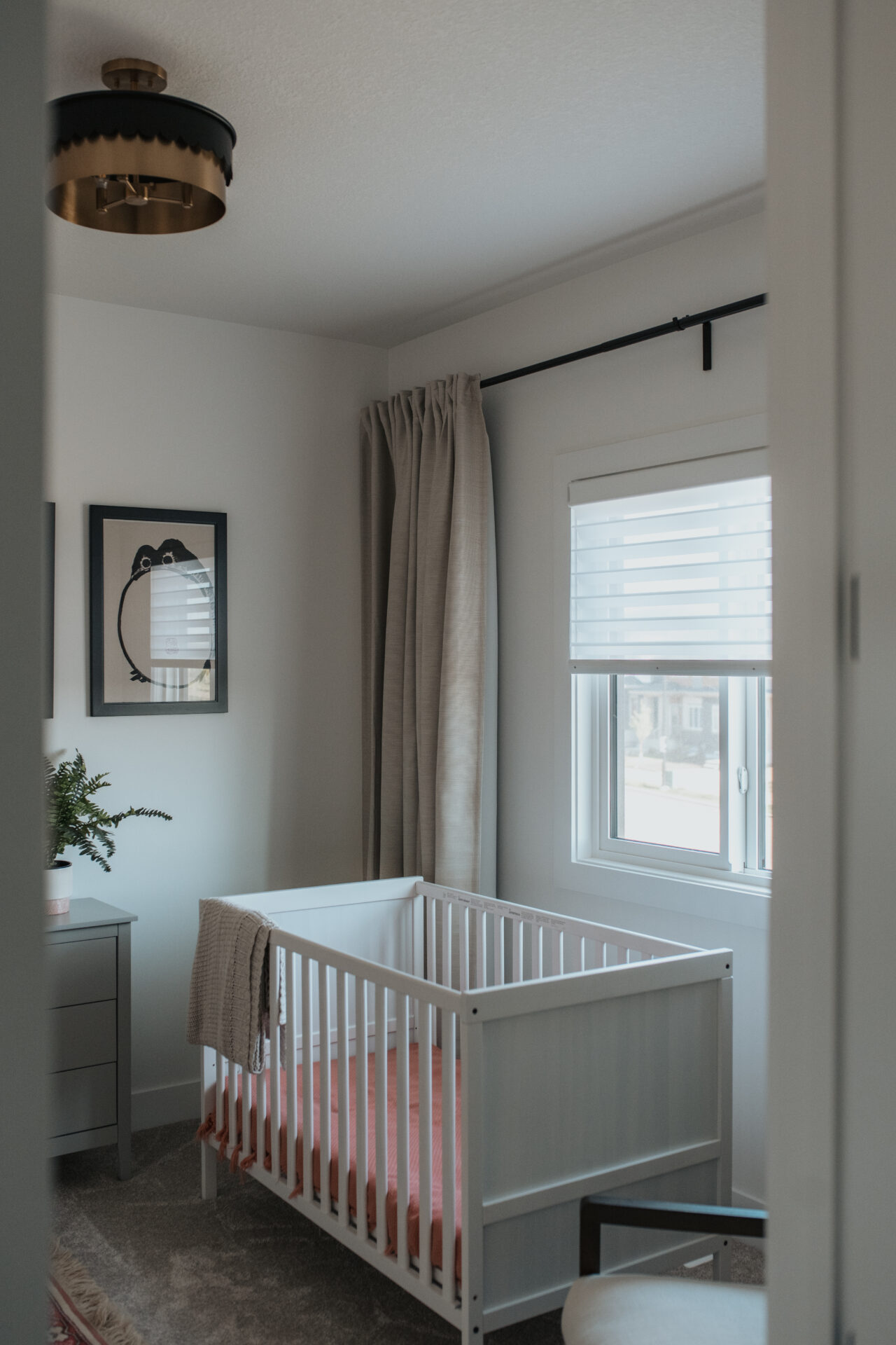 Bright white residential zebra blinds in a custom Edmonton nursery