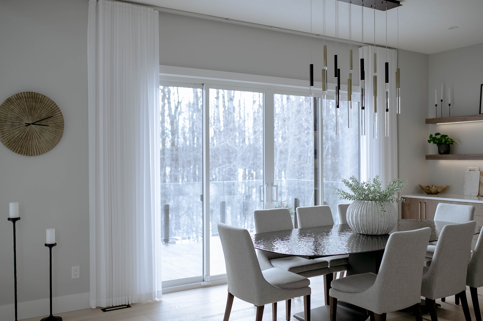 Dining room with Novo roller shades and sheer curtains