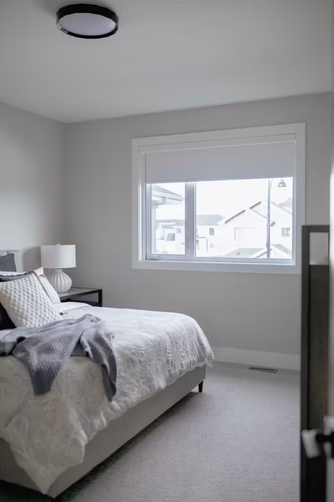 Bright Edmonton bedroom with custom light-filtering roller shades