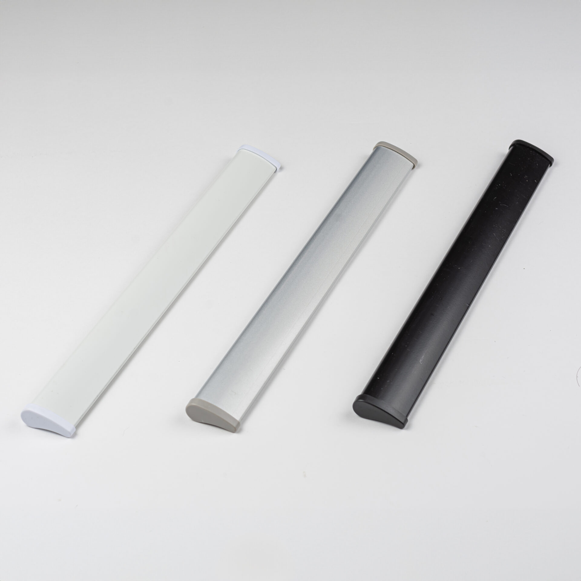 Roller shade bottom rails in white, silver and black