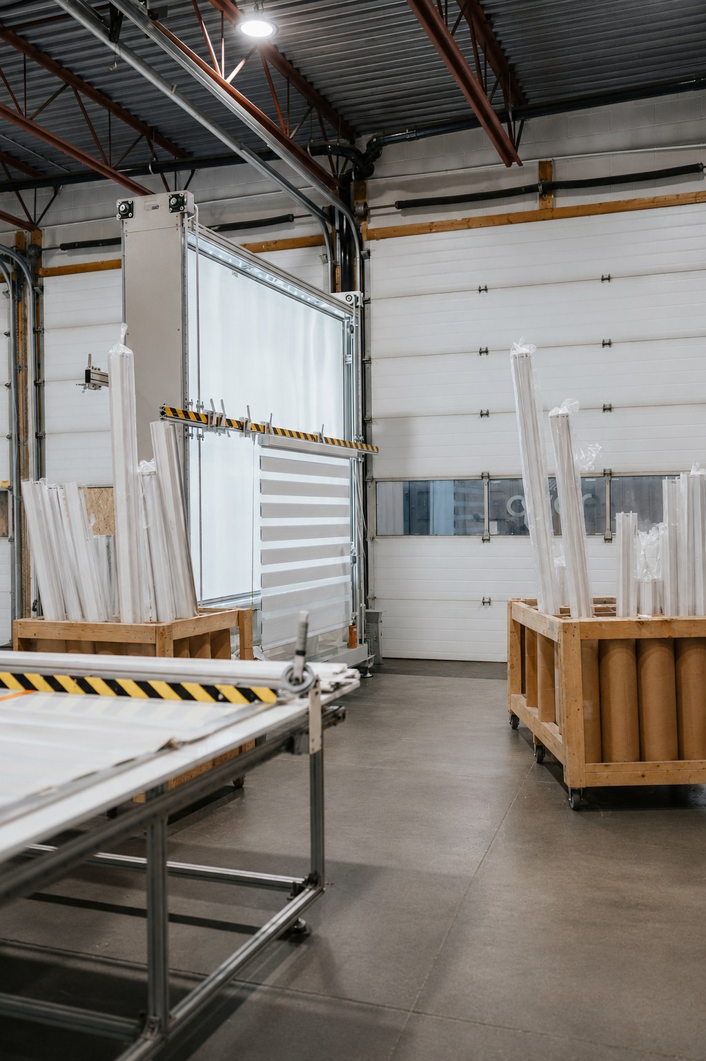 Fabric rolls and component stock on the floor of the Novo Blinds Edmonton factory