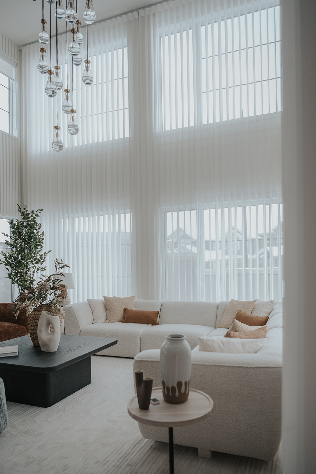 Double-height windows with Novo vertical sheers in a living room