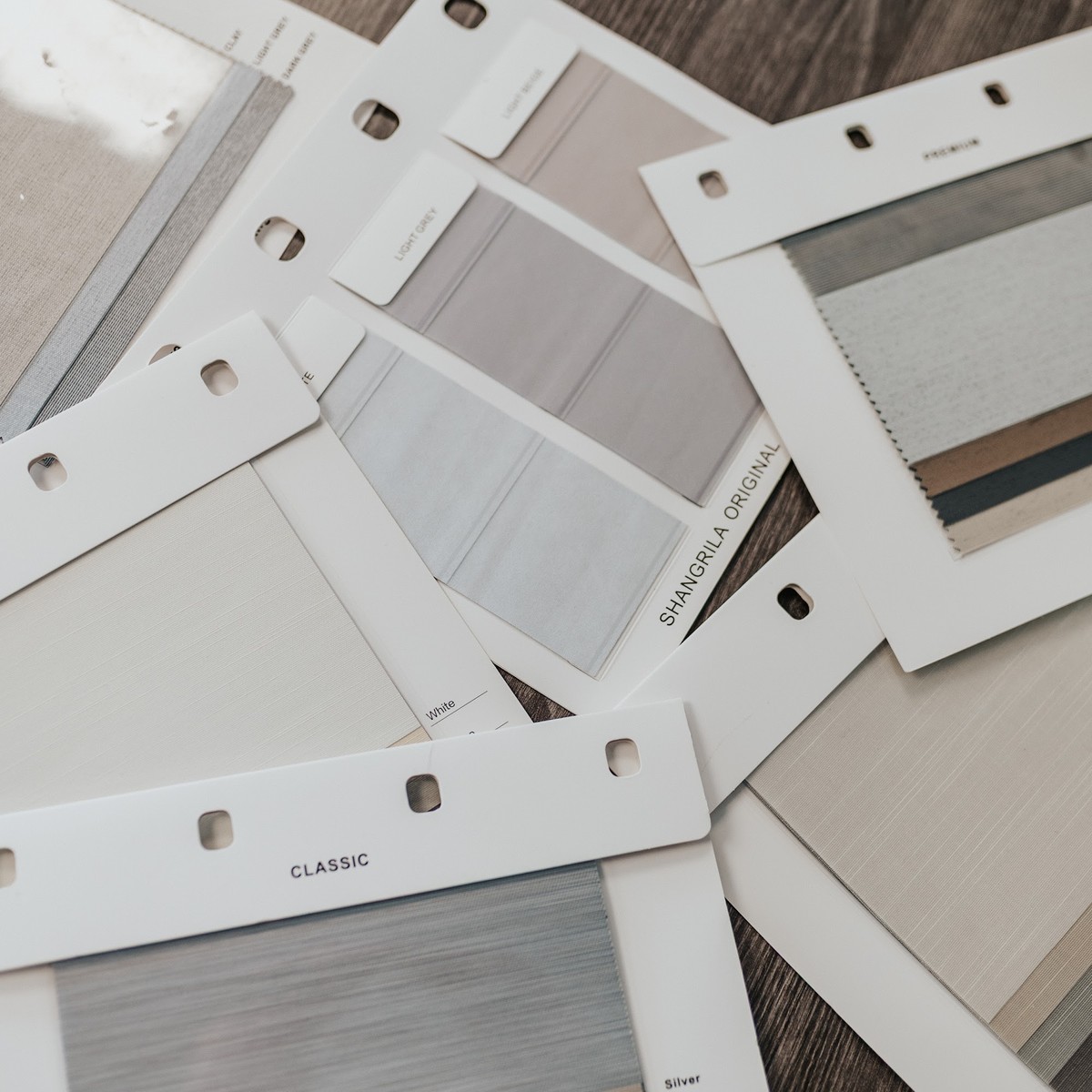 Labelled fabric sample cards showing different colours and textures